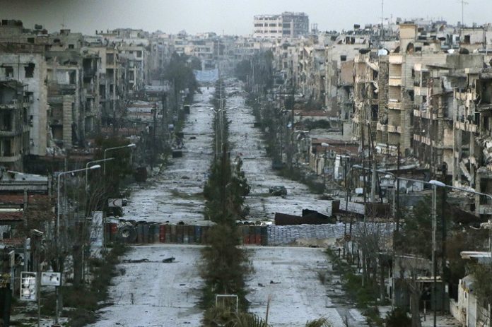 A general view shows a damaged street with sandbags used as barriers in Aleppo's Saif al-Dawla district