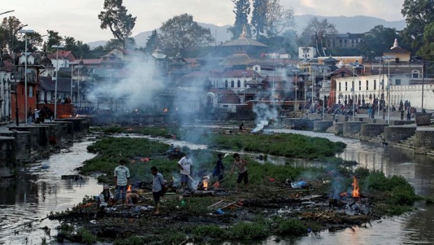 Victims of Saturday's earthquake are cremated along a river in Kathmandu